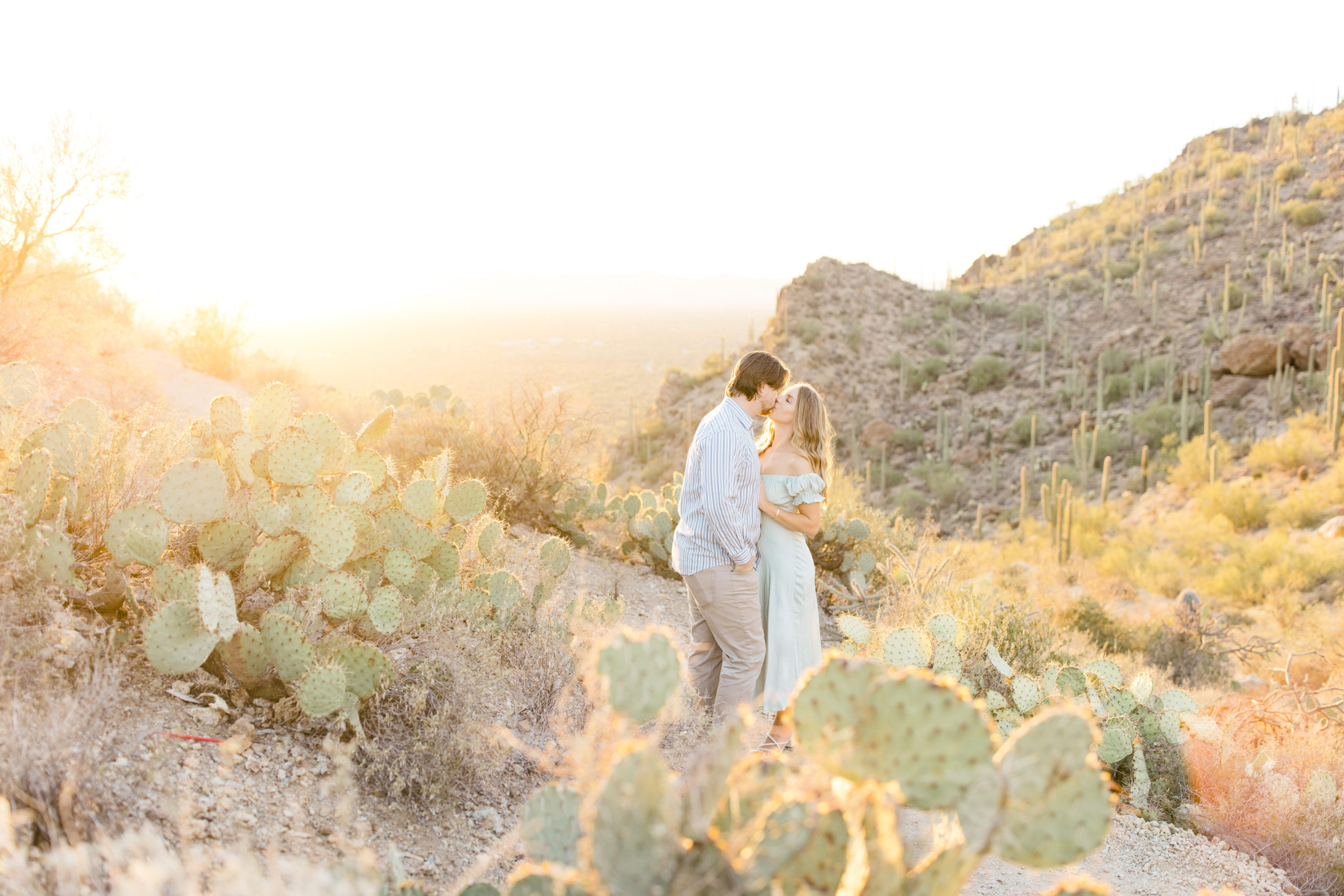 Light and airy fine art engagement photo with cactus in the desert