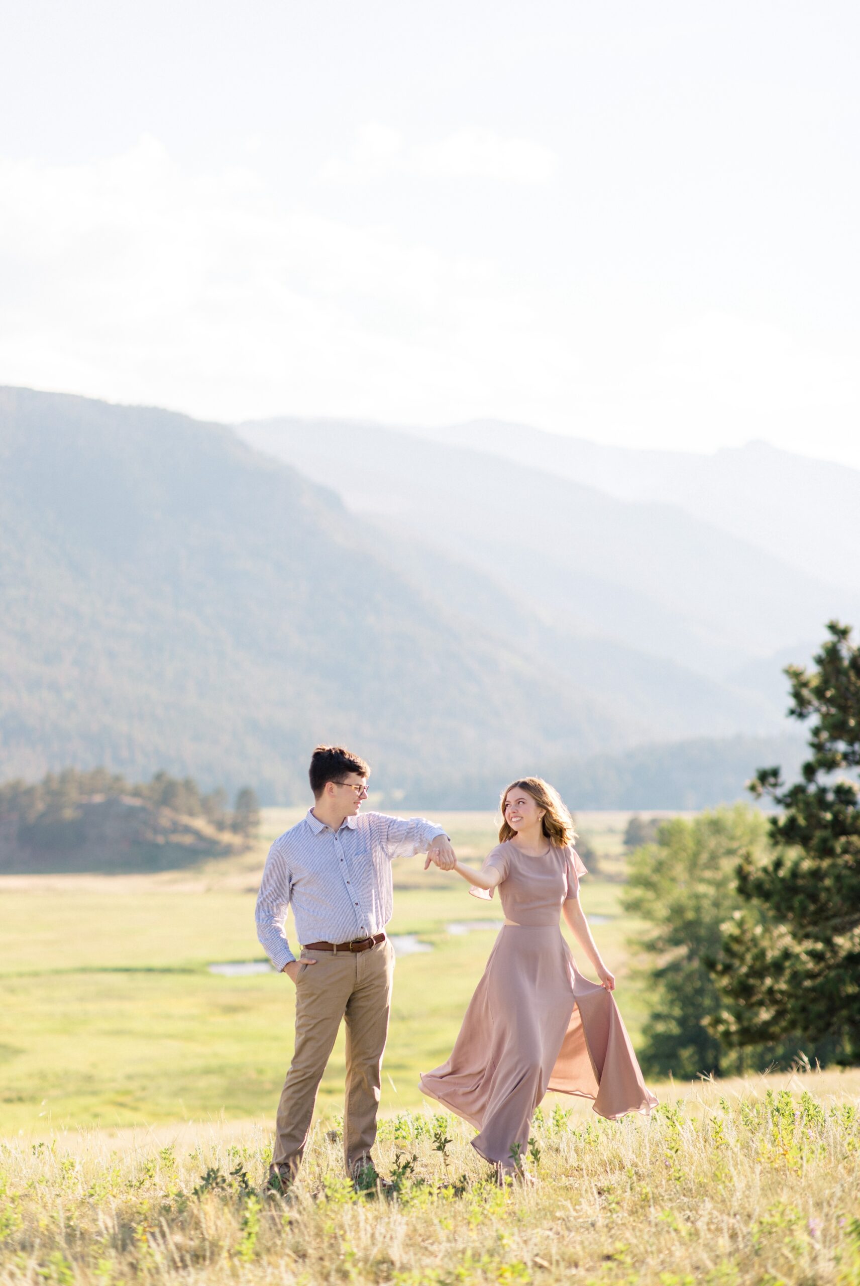 Engagement photo of couple in mountain field in Estes Park, CO