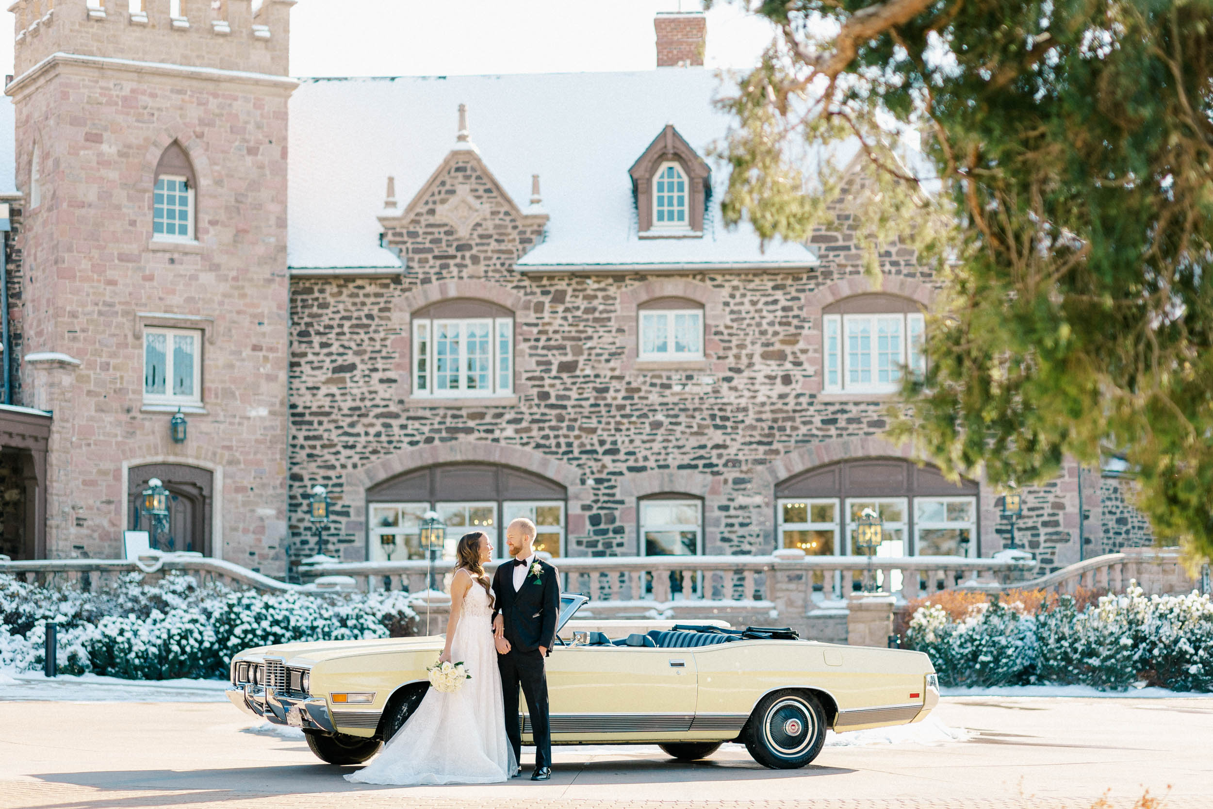 Bride & Groom standing in front of vintage getaway car at the Highlands Ranch Mansion