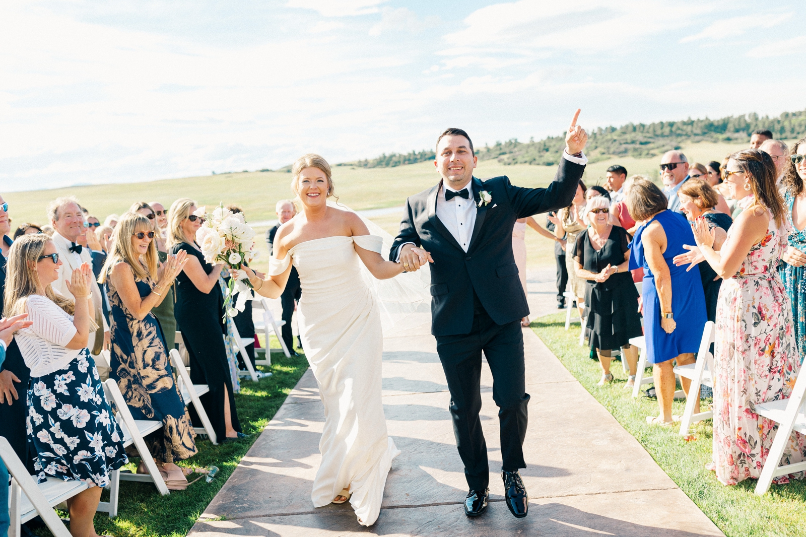 Bright image of the bride and groom exiting the ceremony at the Flying Horse Resort wedding