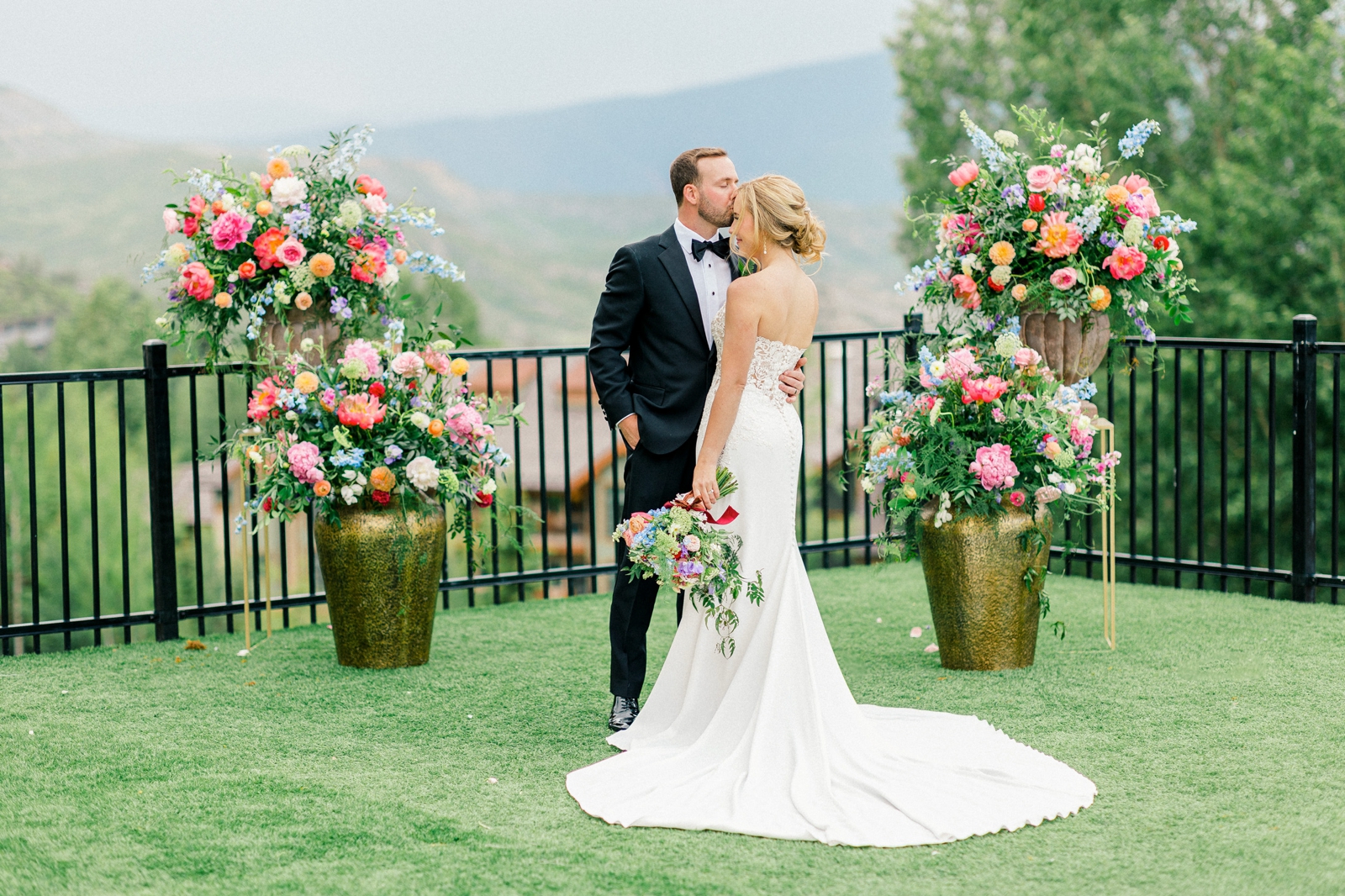 Portrait of Bride and Groom in front of colorful florals at the Viceroy Snowmass